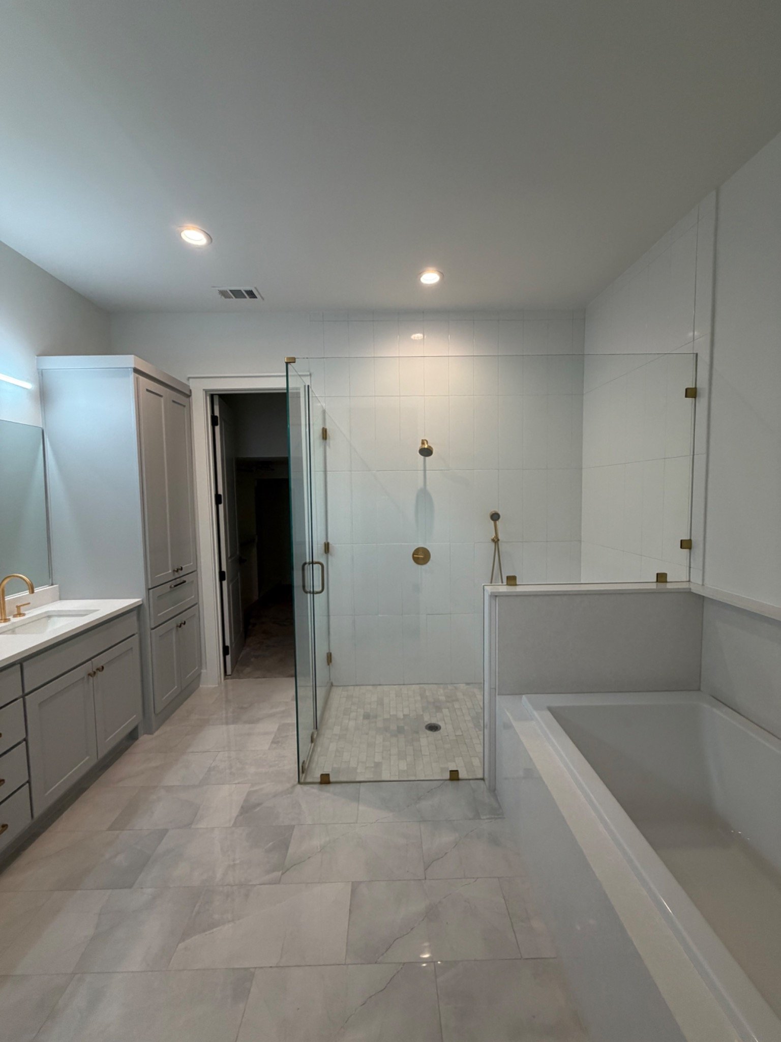 Luxury bathroom with frameless glass shower and tub