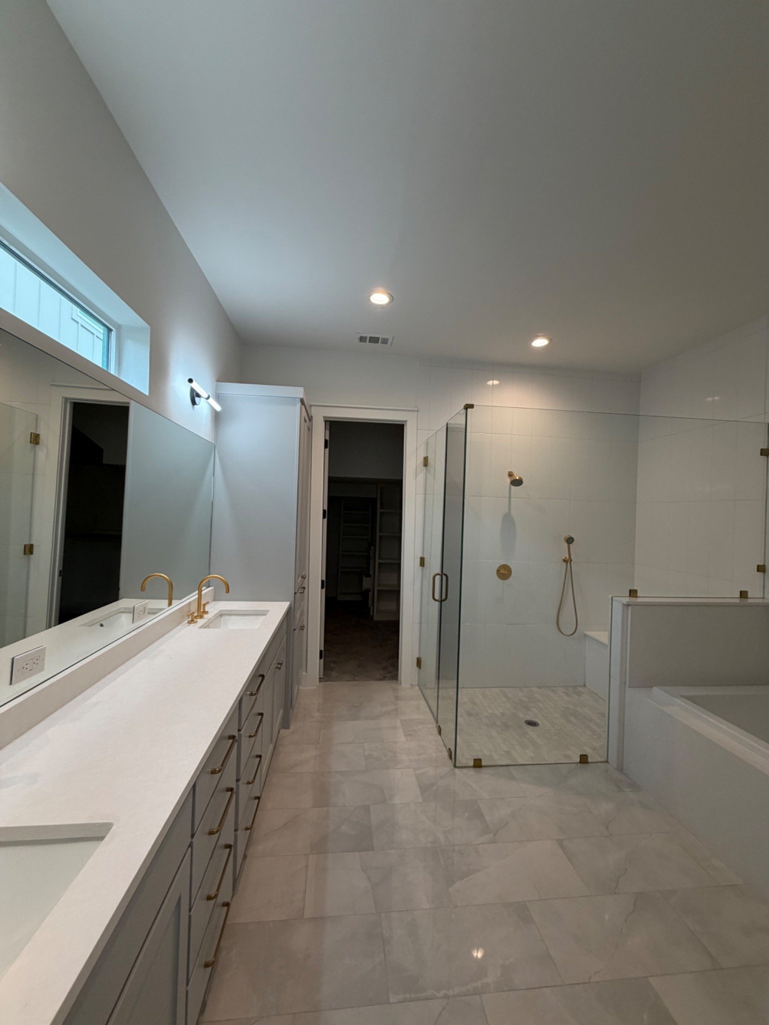 Large primary bathroom remodel with custom glass shower